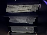 a shelf with towels and towels on it in a room