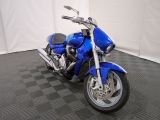 a picture of a blue motorcycle parked on a black and white checkered floor