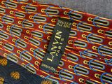 a red tie with blue and yellow designs on it