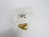 a small bag of gold pieces on a white surface