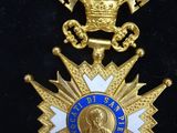a close up of a gold medal with a blue star on it