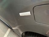 a sticker on the door of a car that is parked on the side of the road