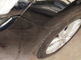 a close up of a car ' s front bumper and tire