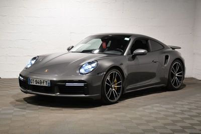 the porsche 911 gts is parked in a large room