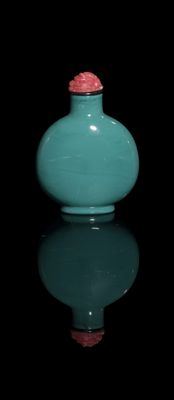 a blue vase with a red lid sitting on a black surface
