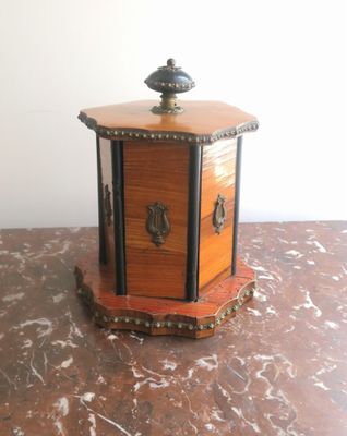 a small wooden box sitting on a marble table