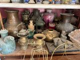 many vases on a shelf in a room