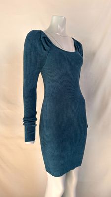 Le mannequin porte une robe bleue à manches longues.