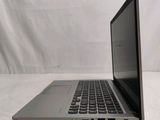 an open laptop computer sitting on top of a white surface
