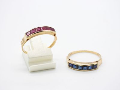 two rings and a ring stand on a white surface