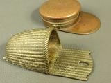a gold hat on a table next to a coin
