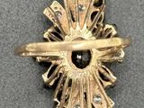 an image of a gold ring with a black stone in the center