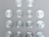 a group of twenty silver coins arranged in a circle