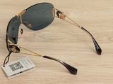 a pair of sunglasses on a wooden table with a price tag