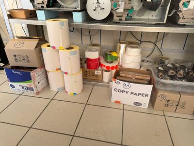 many rolls of paper on a shelf in a room