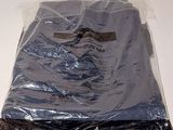 a bag of clothing on a table with a pair of scissors