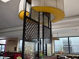 tables and chairs in a restaurant with a large chandelier hanging from the ceiling