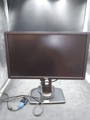 a computer monitor sitting on top of a table