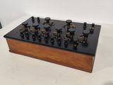 an image of a wooden and black electronic device on a table