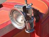 a red and orange car with a steering and a steering wheel