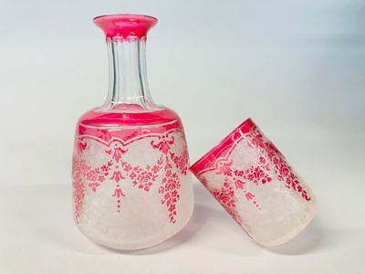 two glass vases sitting next to each other on a table
