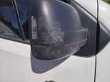 a side view mirror of a car with a denting on it