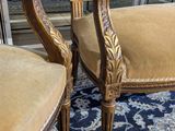 pair of carved wood chairs with upholstered upholstered cushions