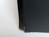 a close up of a black book on a white table