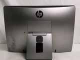 the hp monitor is sitting on the table next to the mouse