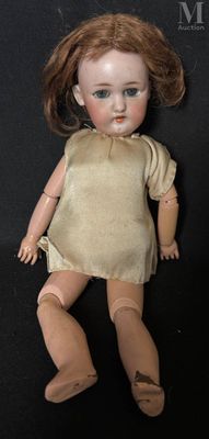 a doll that is laying down on a black surface