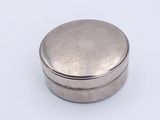 a small silver box with a lid on a white surface