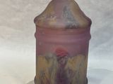 purple and yellow glass jar with a lid on a white surface