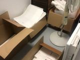 a room with boxes and a fan on the floor