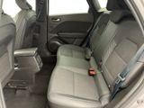 the back seats of a car with a remote control in it