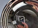 reflection of a person taking a picture of themselves in a mirror