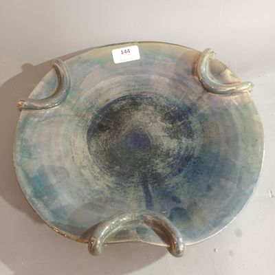 a blue and white plate on a table with a sticker on it