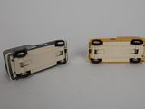 two small toy cars sitting side by side on a table
