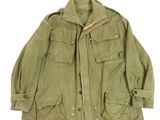 a green jacket with buttons on the chest and a buttoned collar