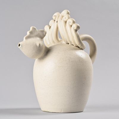 a white vase with a bird on top of it