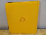 the yellow ipad case is sitting on top of a wooden table
