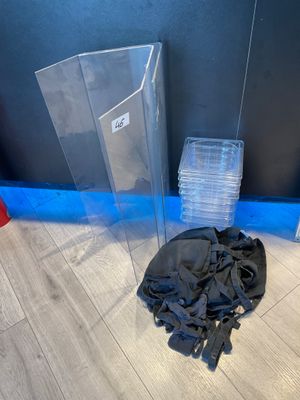a pile of plastic items on the floor next to a wall