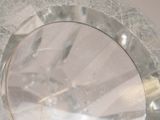 a clear glass plate with a silver rim on a table