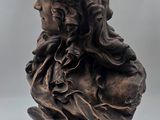 a close up of a statue of a woman with long hair
