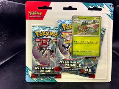 two pokemon cards are in a package on a black surface