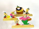 cartoon figurines of a man and a woman with a pot of gold on a shelf