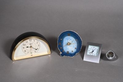 two clocks and a small clock sitting on a table