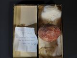 an apple in a box with a note on it