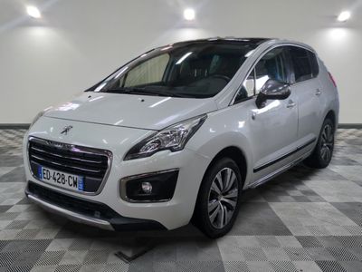 the small white car is parked in a large room