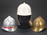 three different types of helmets on display on a black surface