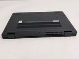 the back of a black laptop computer sitting on top of a white table